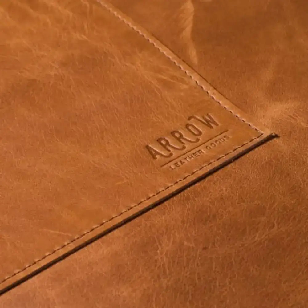 Close-up of a brown leather product with 'Arrow Leather Goods' branding.