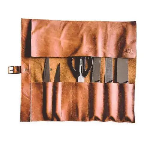 Brown leather apron with cutlery pockets on a white background