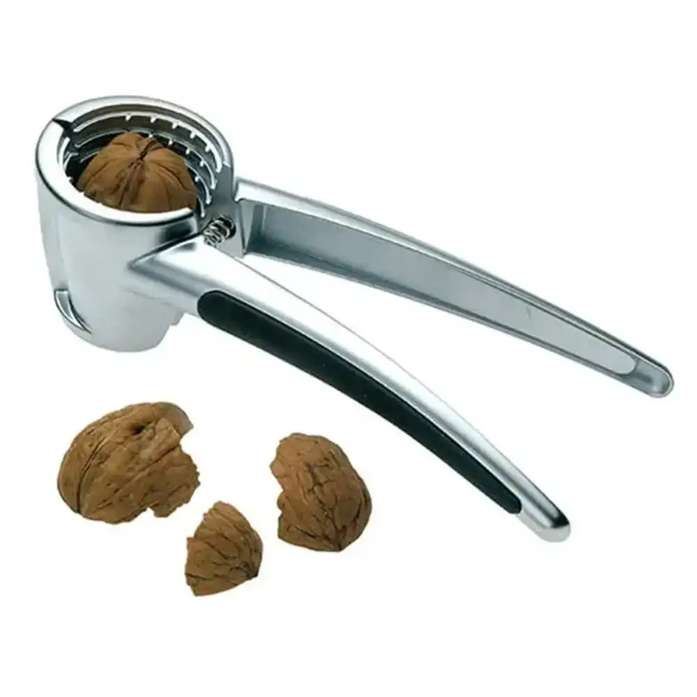 Metallic nutcracker with cracked walnuts on a white background