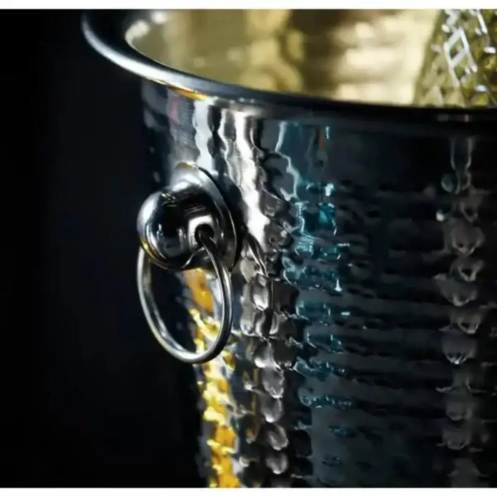 Close-up of a silver wine cooler with a textured surface and metallic finish.