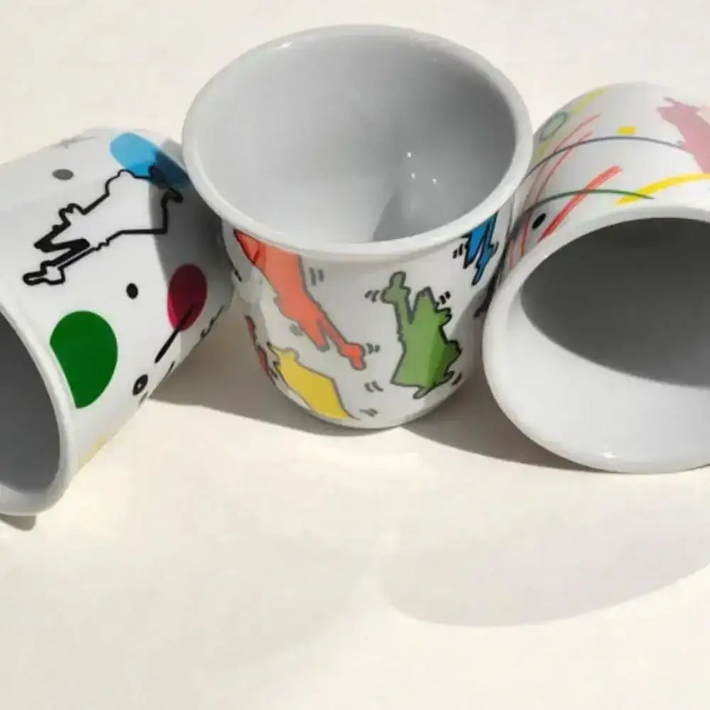 Set of three Bialetti Arte espresso cups with colorful abstract designs on white ceramic