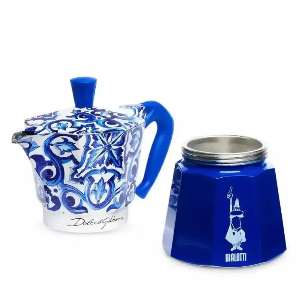 Blue and white ceramic teapot with decorative patterns next to a blue Bialetti coffee maker on a white background.