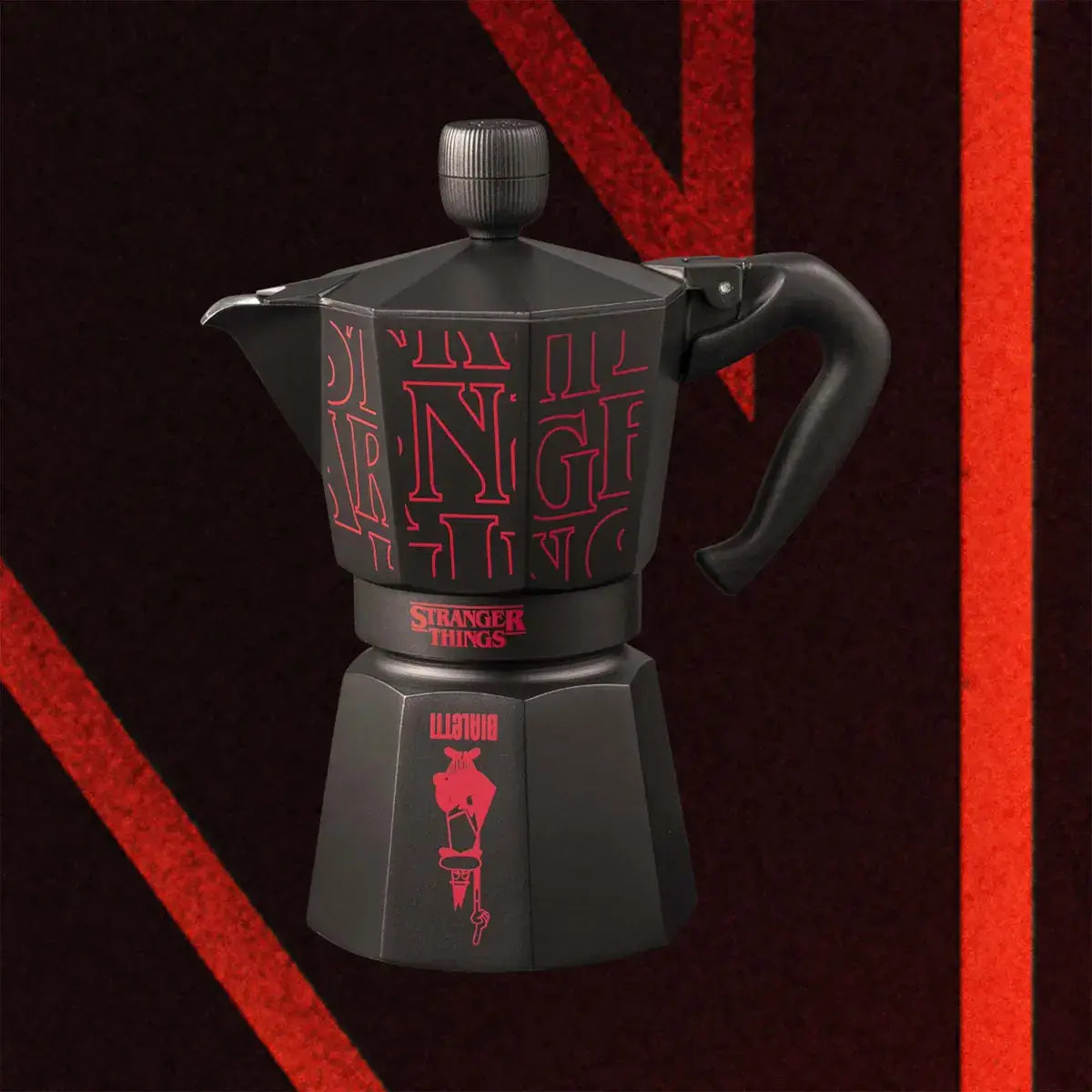 Black coffee maker with red text on a dark background