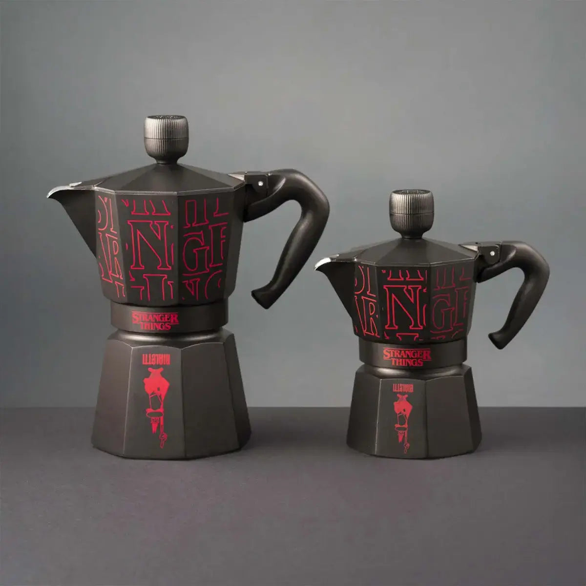 Two black coffee pots with red text on a gray background