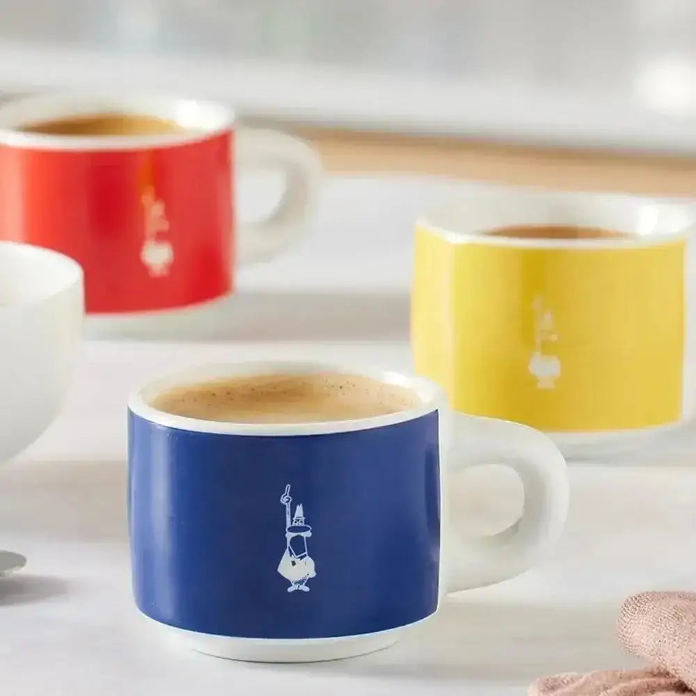 Colorful coffee mugs with designs on a light background
