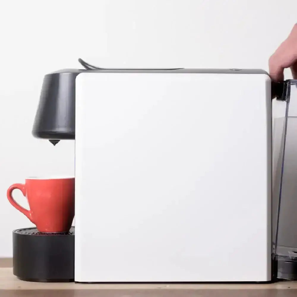 White capsule coffee machine with red cup on kitchen countertop at Cookin Stores