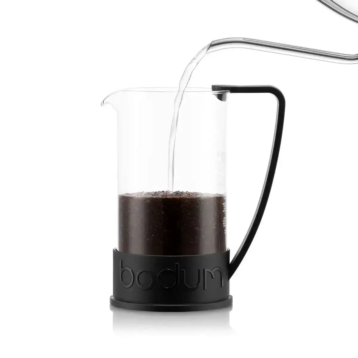Bodum coffee press with coffee inside on a white background