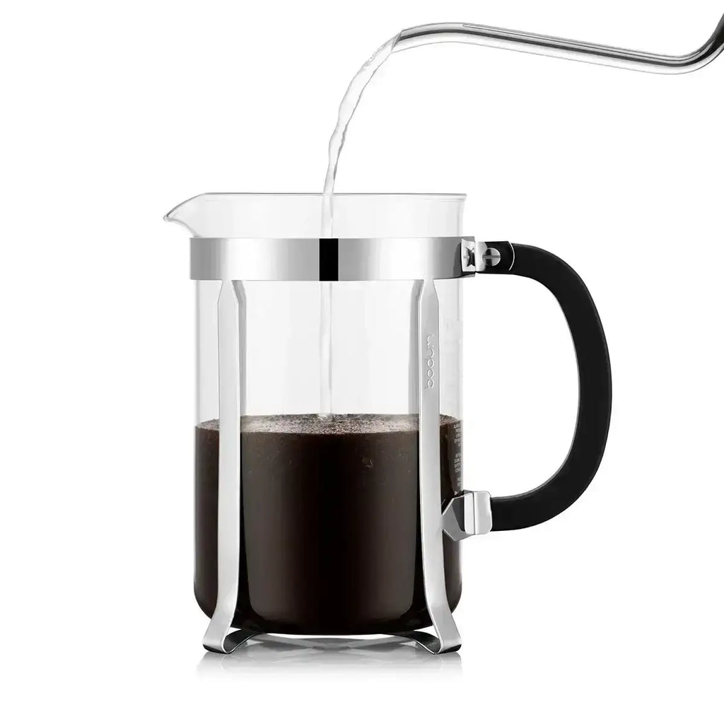 French press with coffee on a white background