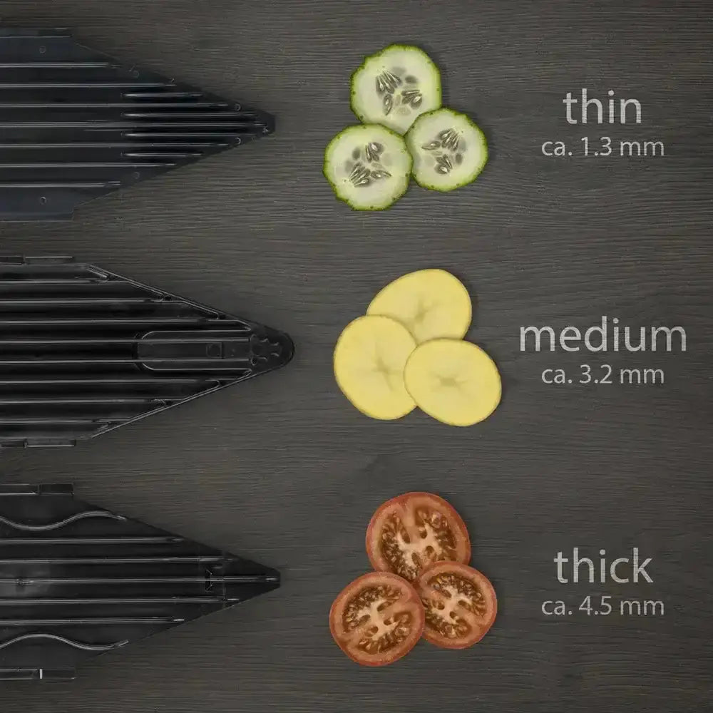 Black triangular grill plates with parallel ridges from borner v6 exclusiveline basic mandolin set shown with sliced cucumber banana and tomato