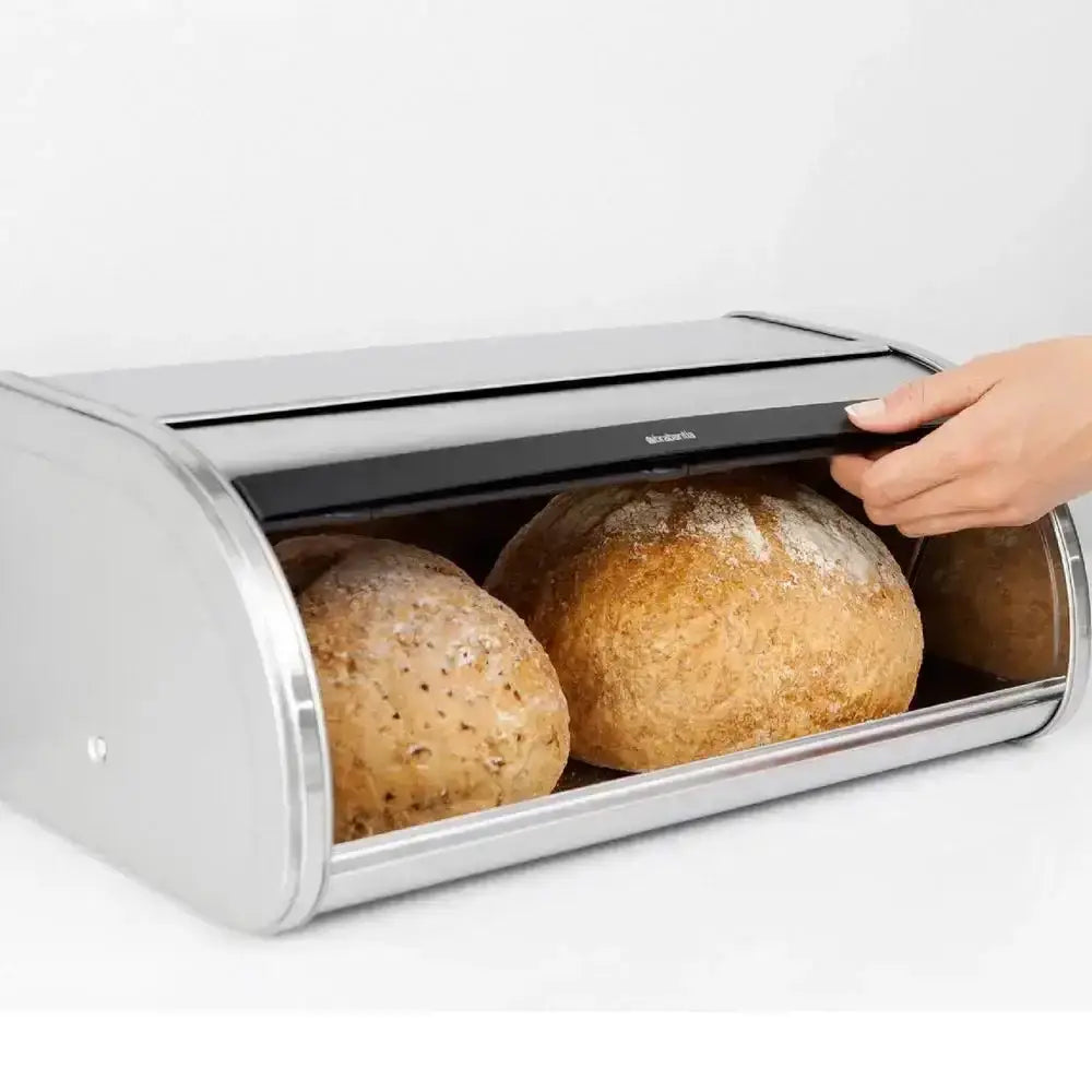 Silver bread box with loaves of bread inside on a white background