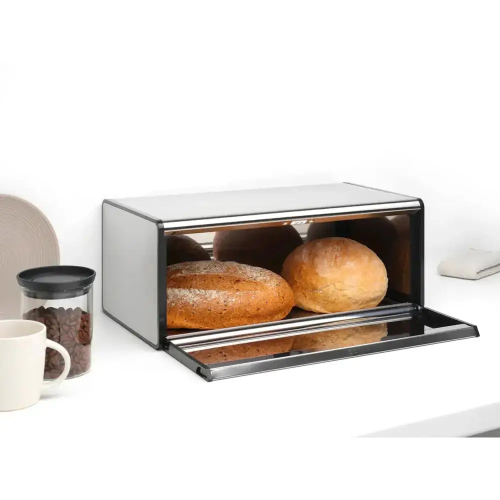 Modern bread toaster with loaves of bread on a white background