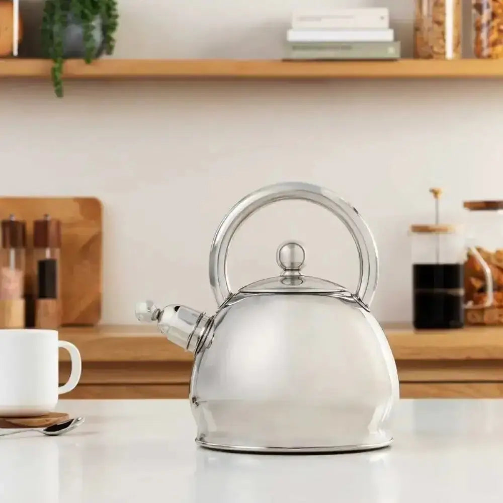 Silver kettle on a kitchen counter with a blurred background