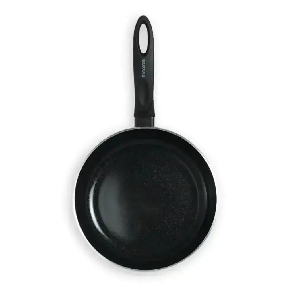 Black frying pan with a handle on a white background