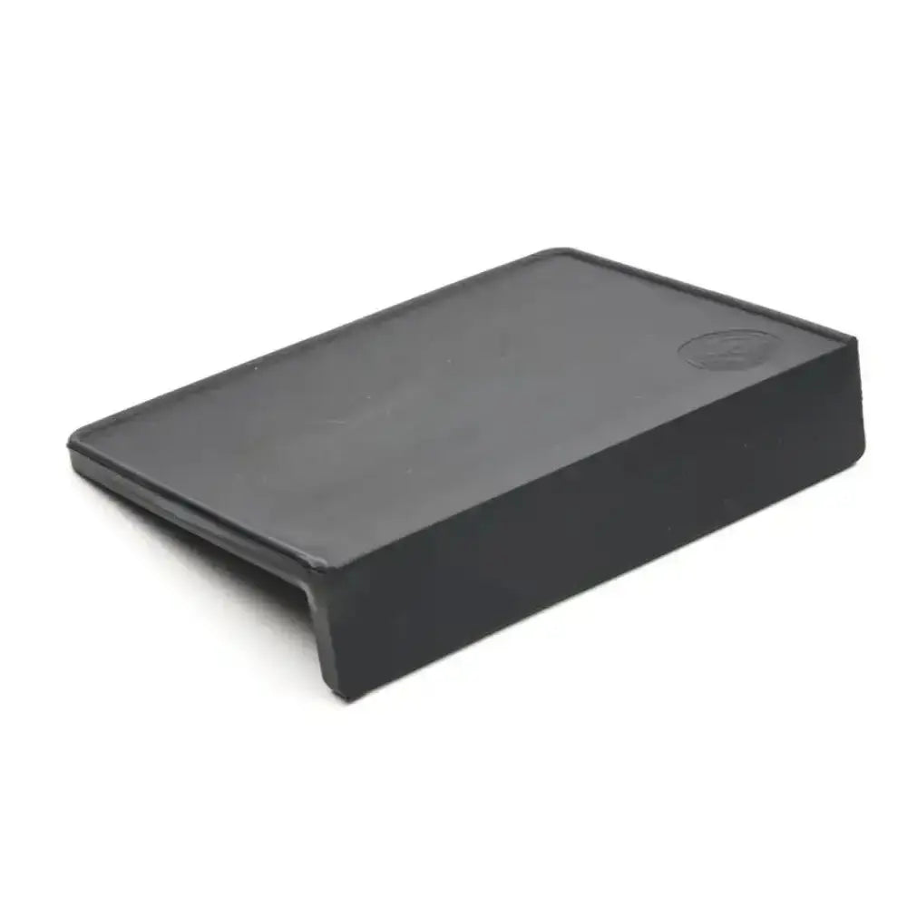 Black rectangular plastic component on a white background