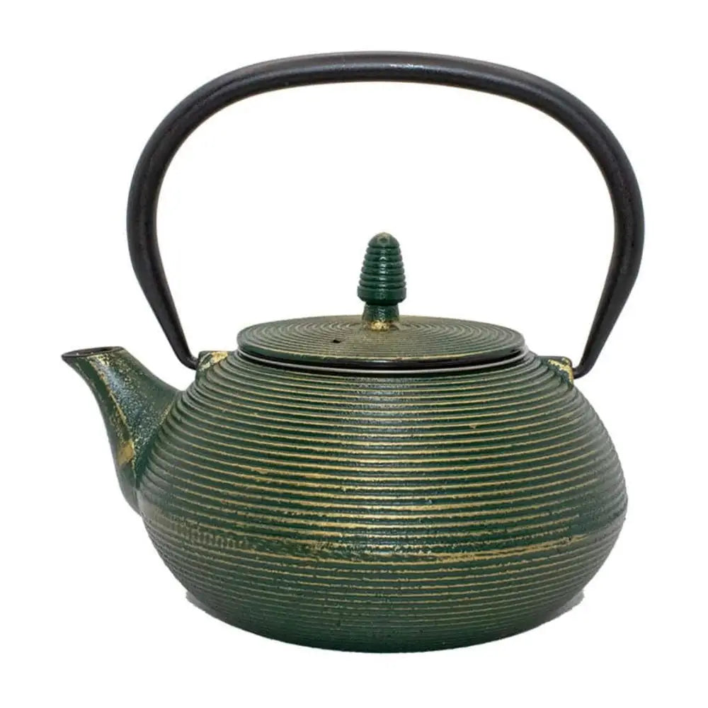 Green cast iron teapot with ribbed design on a white background