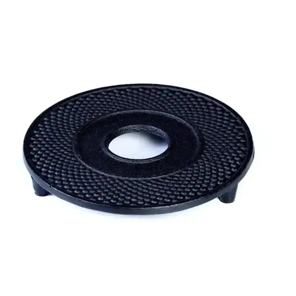Black circular object with textured surface on a white background