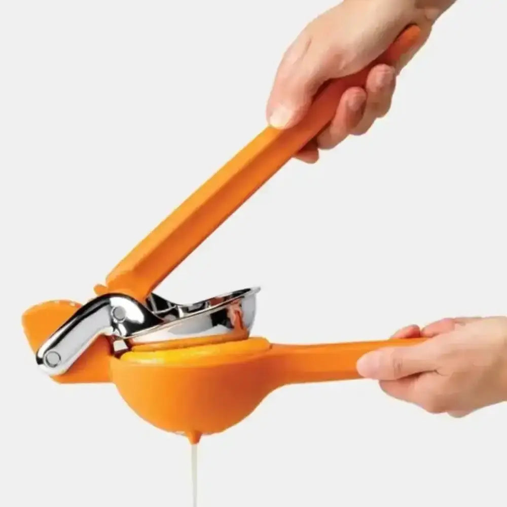 Orange manual juicer being used with a white background