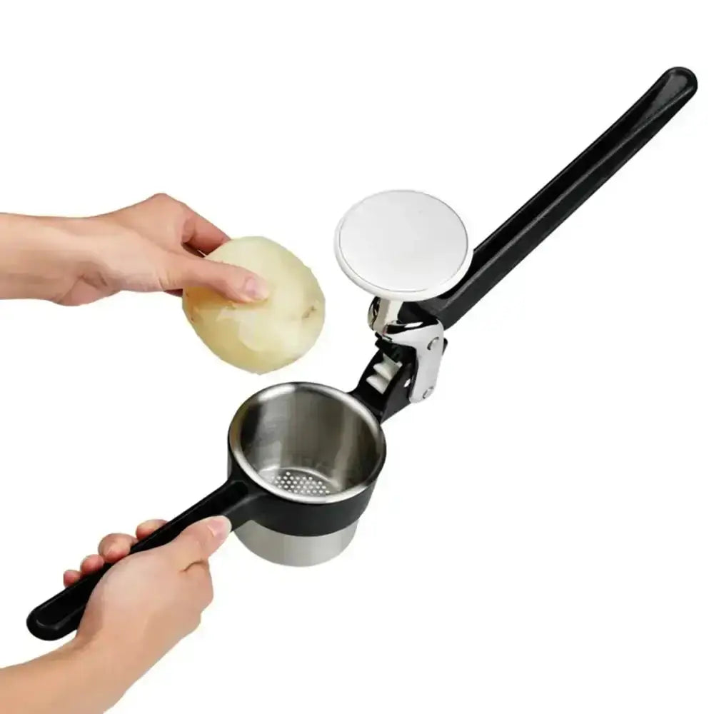 Potato ricer being used on a white background
