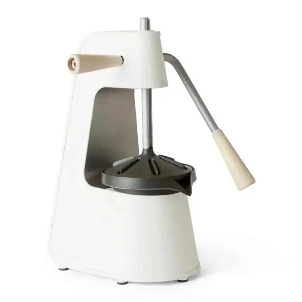 Manual juicer with white top and base on a white background