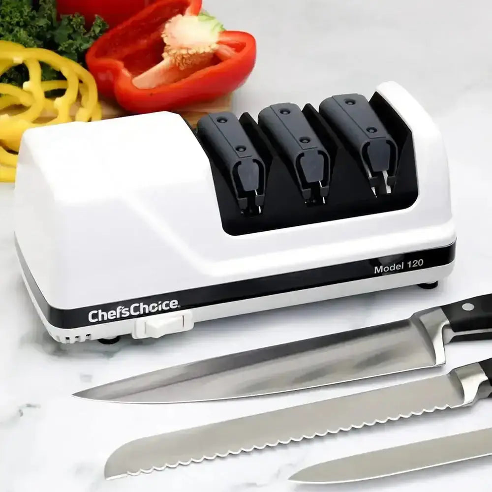 Three-stage electric knife sharpener with kitchen knives and sliced vegetables on countertop