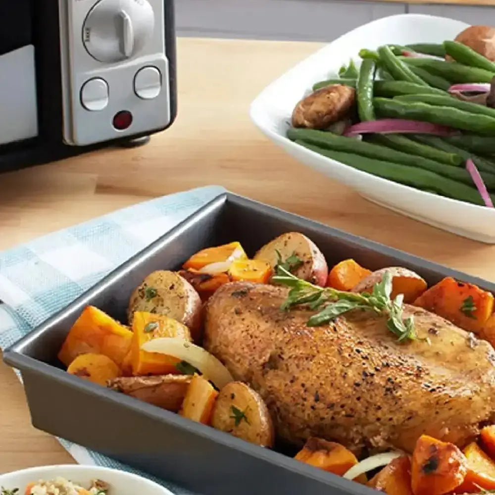 Chicago Metallic non-stick bakeware with roasted chicken and vegetables, Cookin Stores kitchenware.