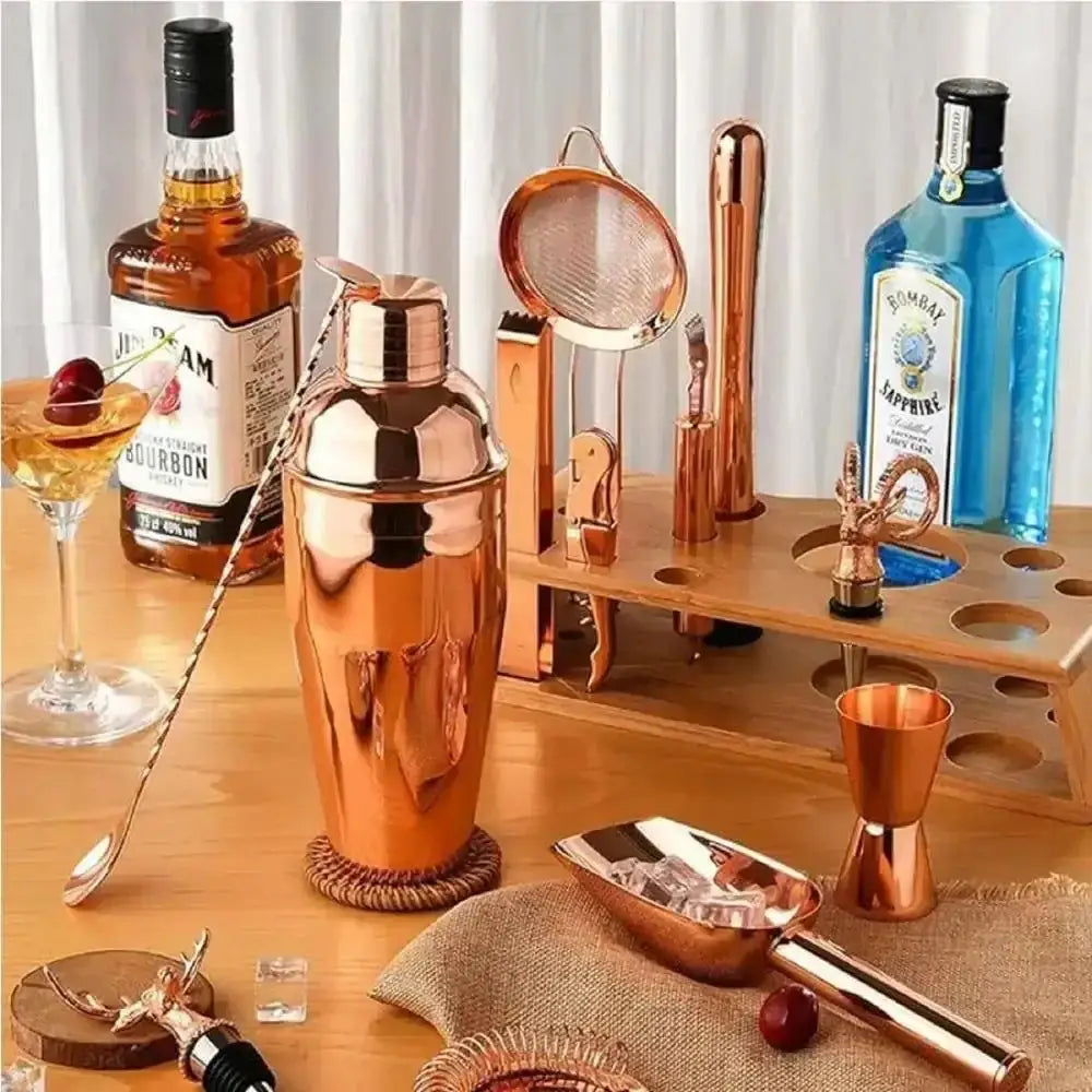 Copper cocktail shaker set with barware and spirits on wooden table at Cookin Stores