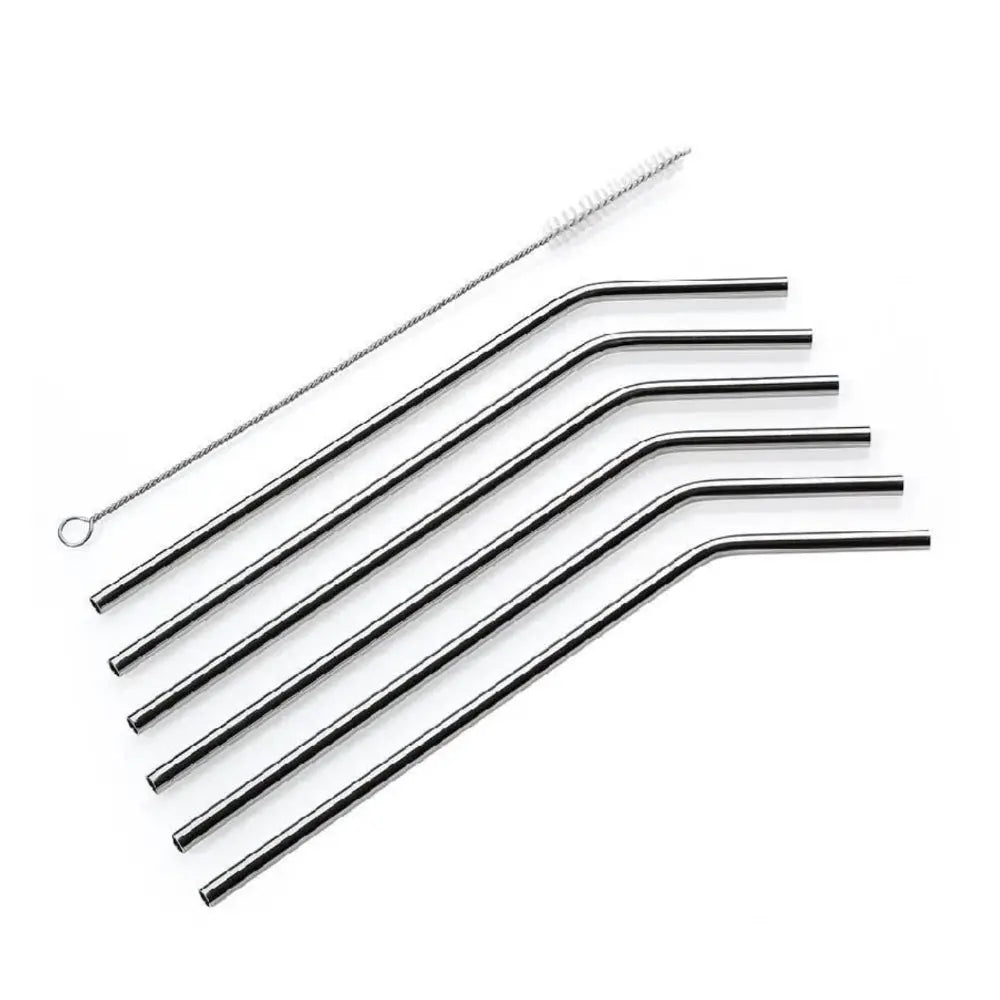 Set of metal straws and cleaning brush on a white background