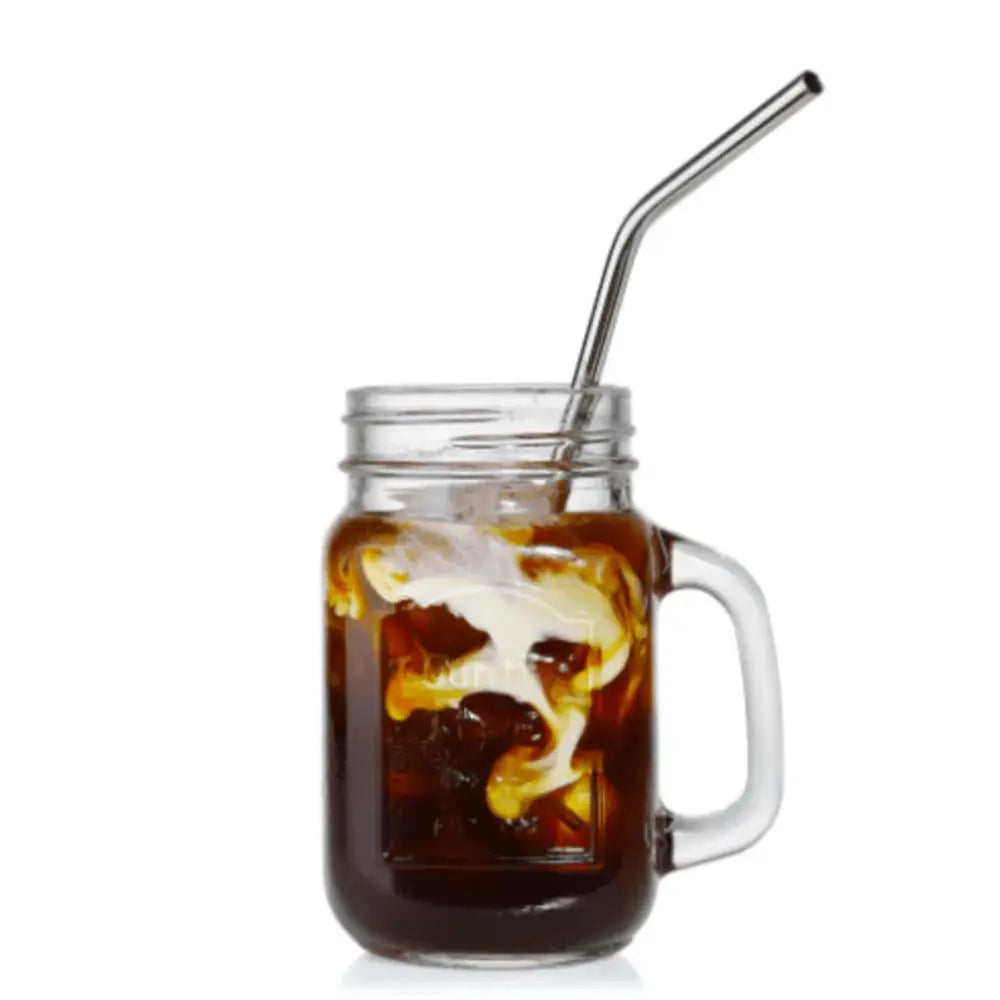Glass mug with iced coffee and a metal straw on a white background