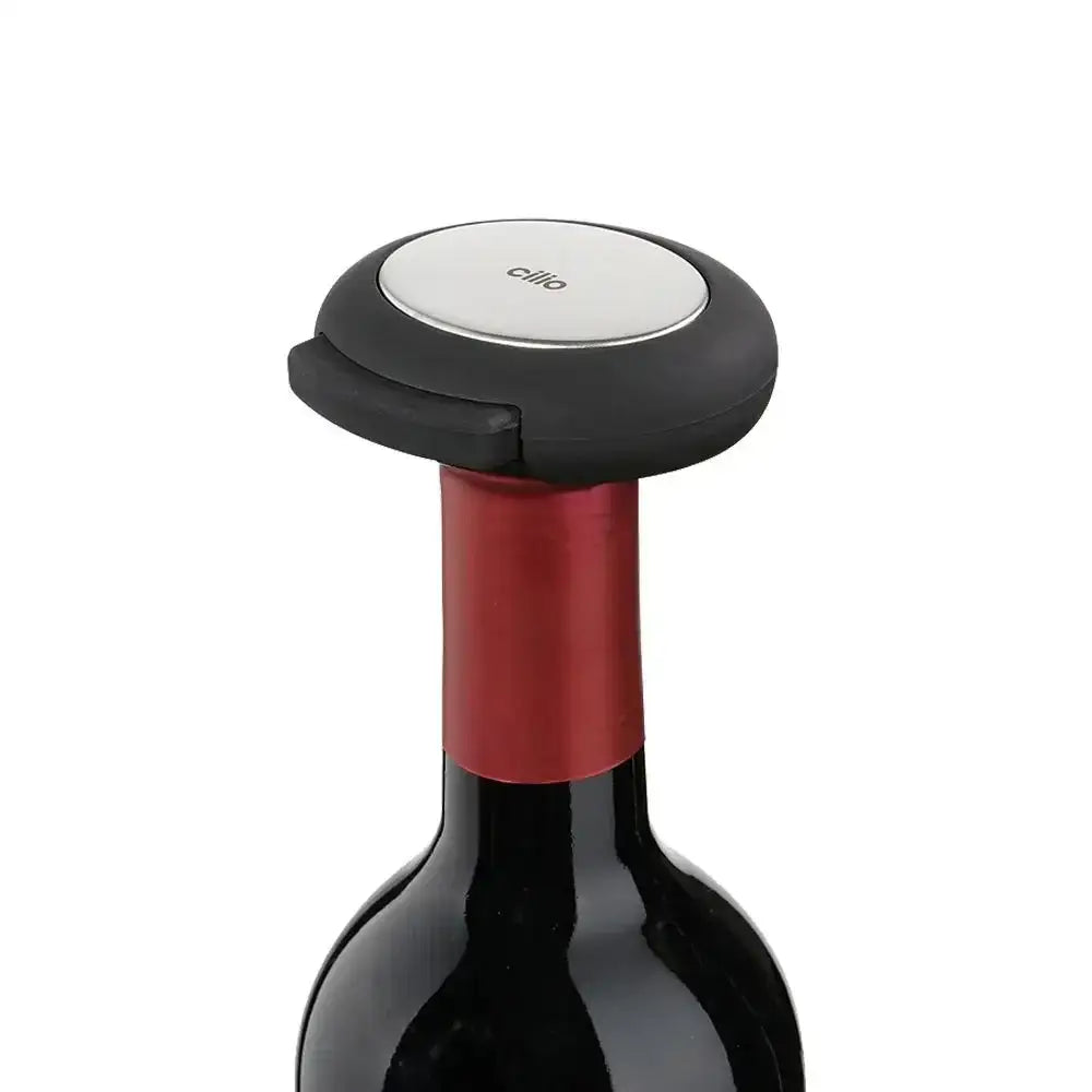 Wine bottle with a red wine stopper on a white background