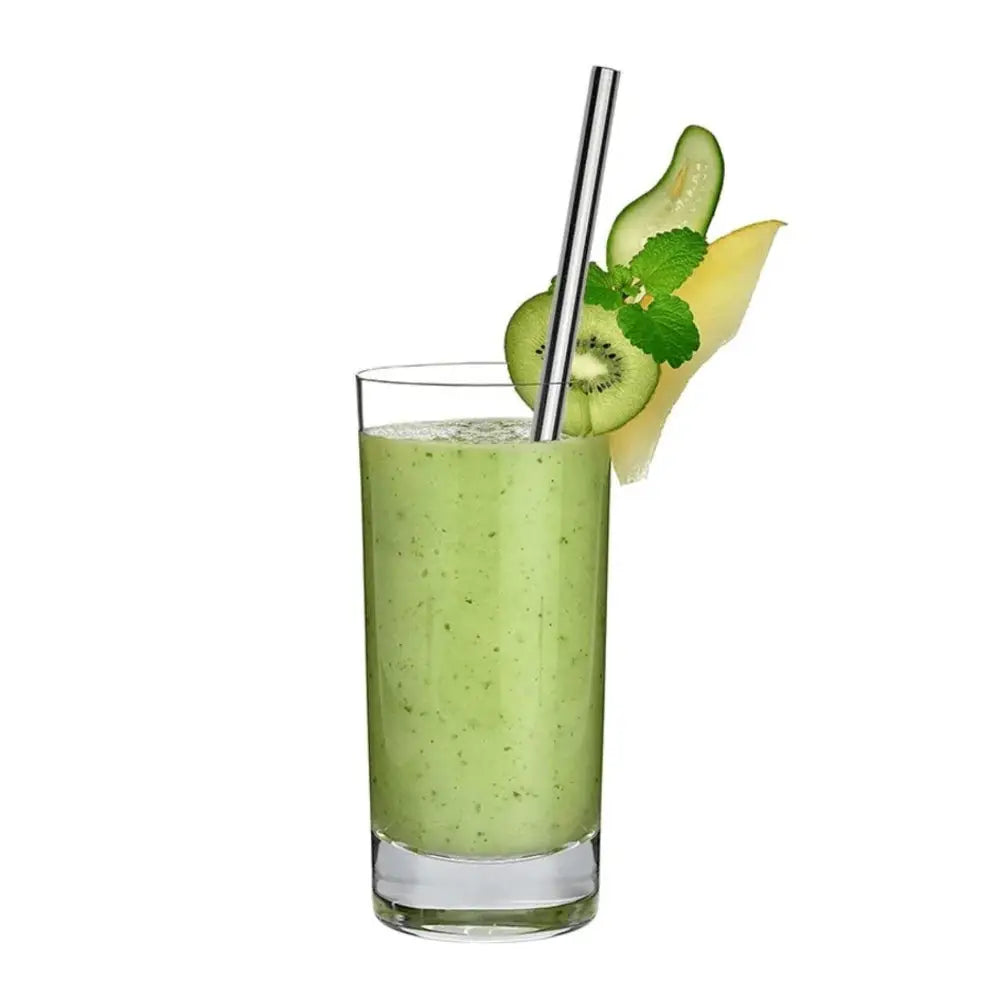 Green smoothie in a glass with a straw, kiwi slice, and pineapple wedge on a white background
