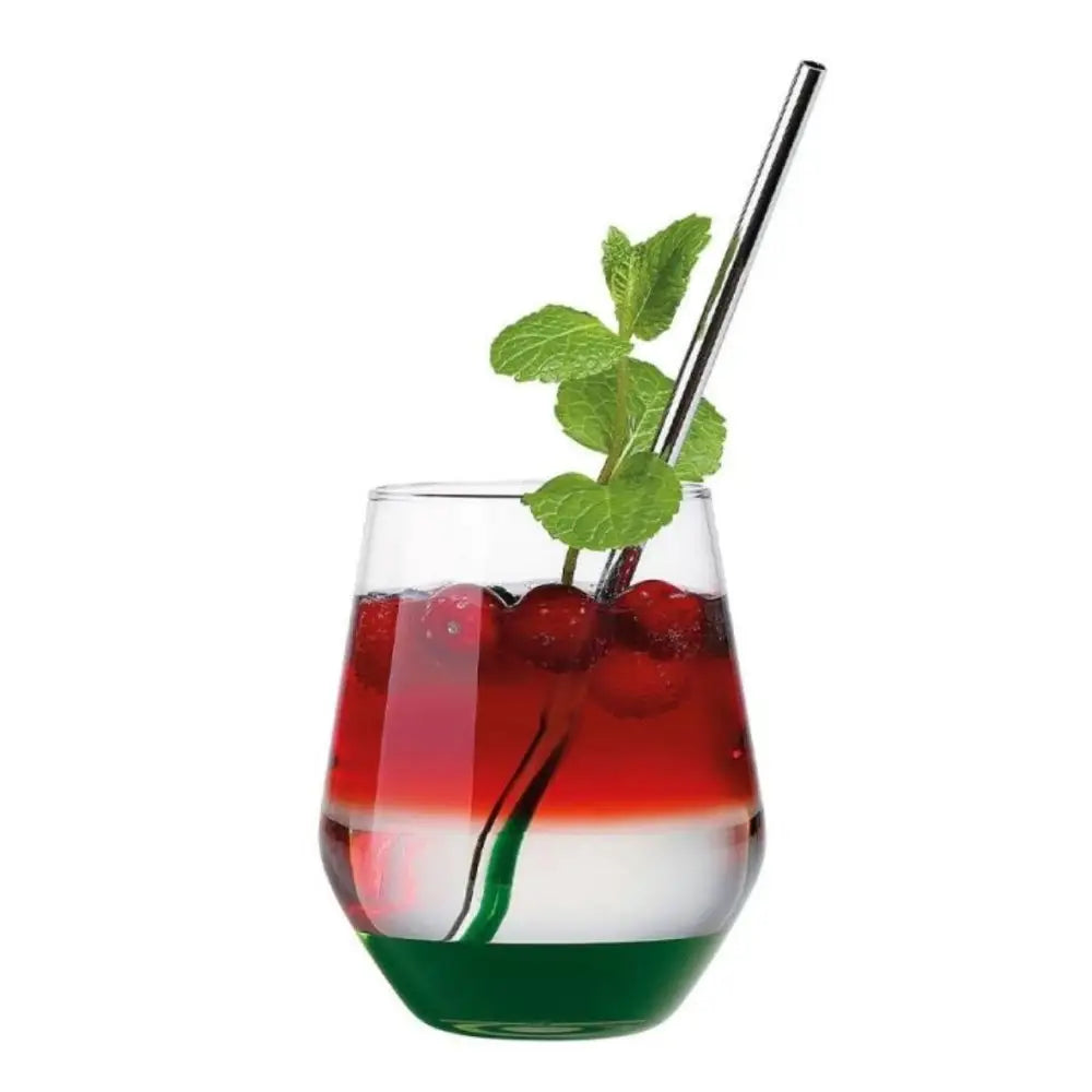 Colorful layered drink in a glass with a metal straw and mint leaf on a white background