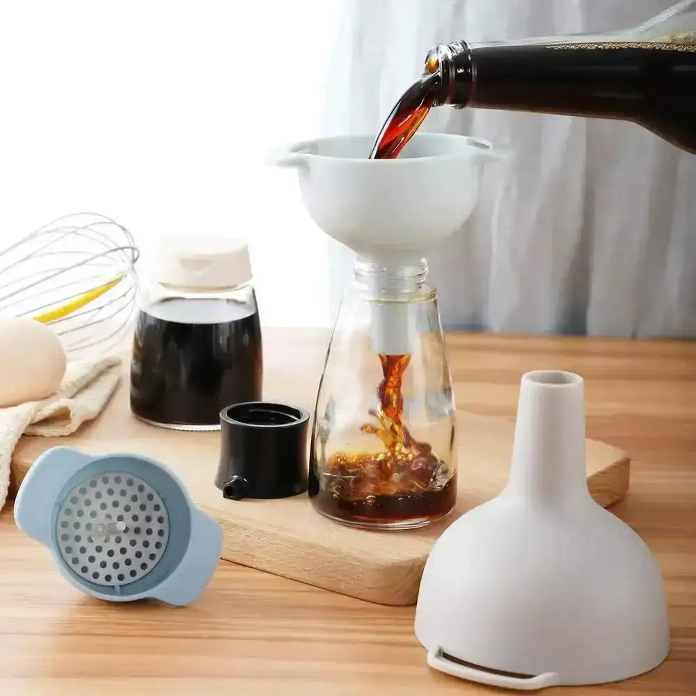 Pouring liquid into a glass container with kitchen tools on a wooden surface