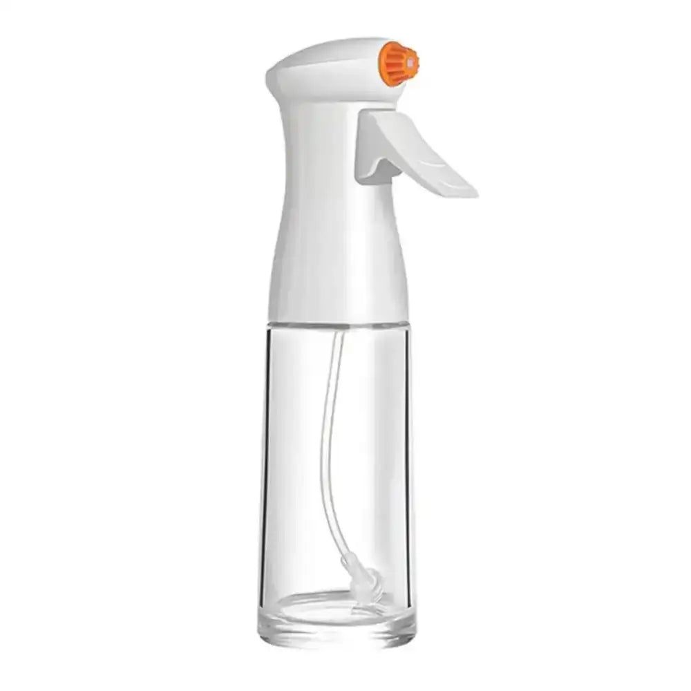 Clear spray bottle with white nozzle on a white background