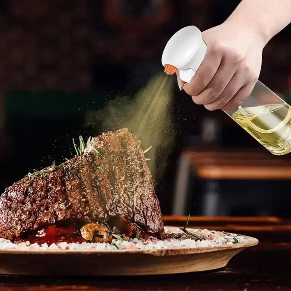 Person spraying a liquid over a roasted dish on a wooden plate.