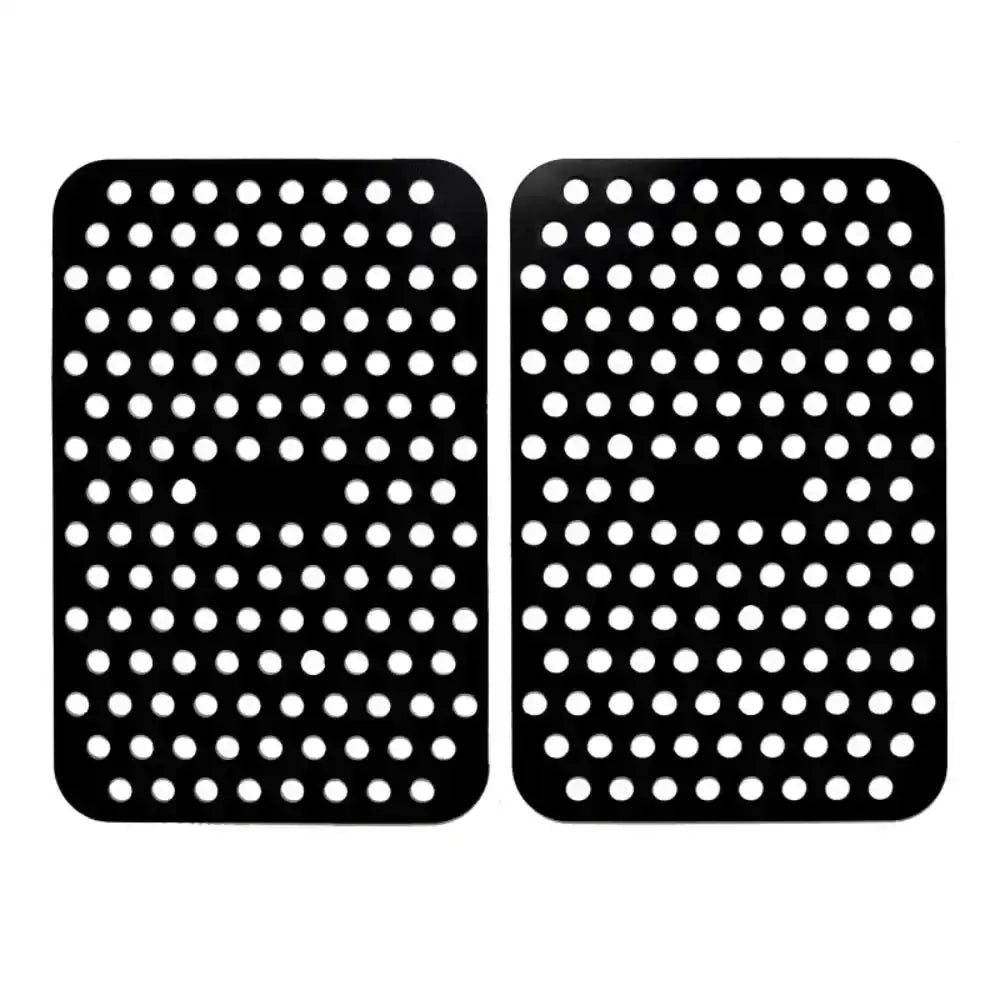 Two black rubber mats with white circular patterns on a white background