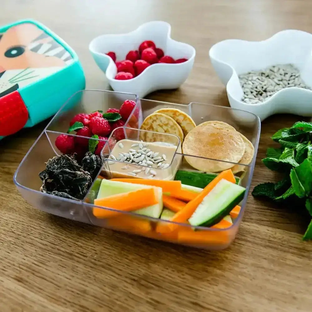 Blue Crunchbox Classic lunchbox with fruit, pancakes, veggies, and seeds on wooden table, Cookin Stores