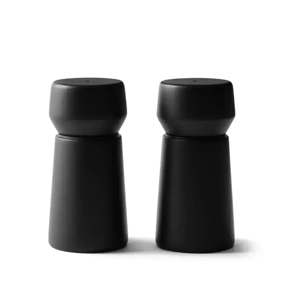 Set of two black beech wood grinders with modern design on white background