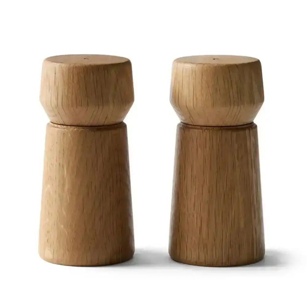 Set of two modern oak wood grinders for salt and pepper on a white background