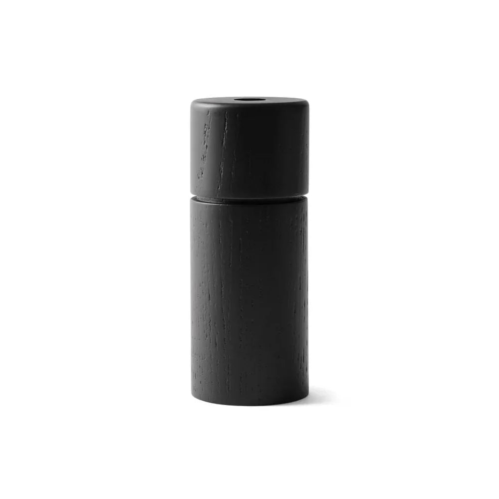 Black cylindrical pepper grinder on a white background