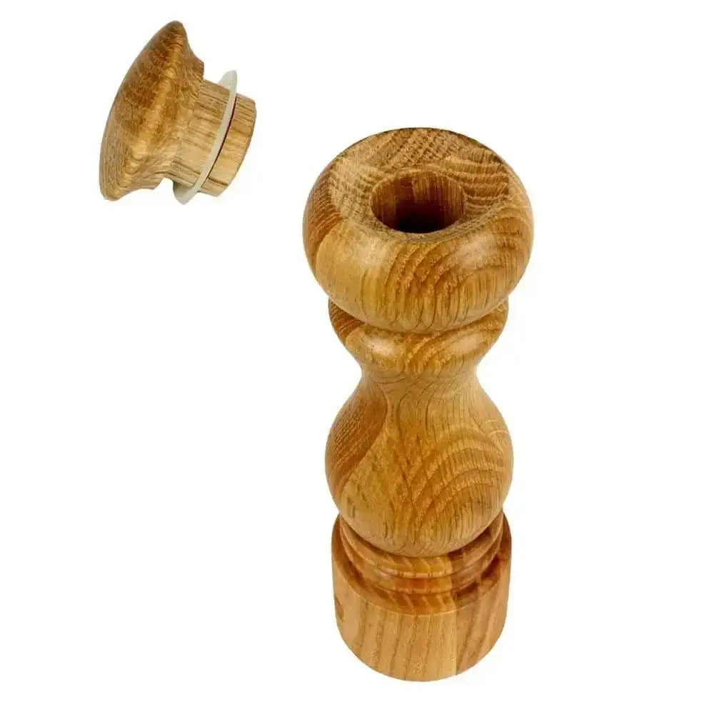 Wooden pepper grinder on a white background