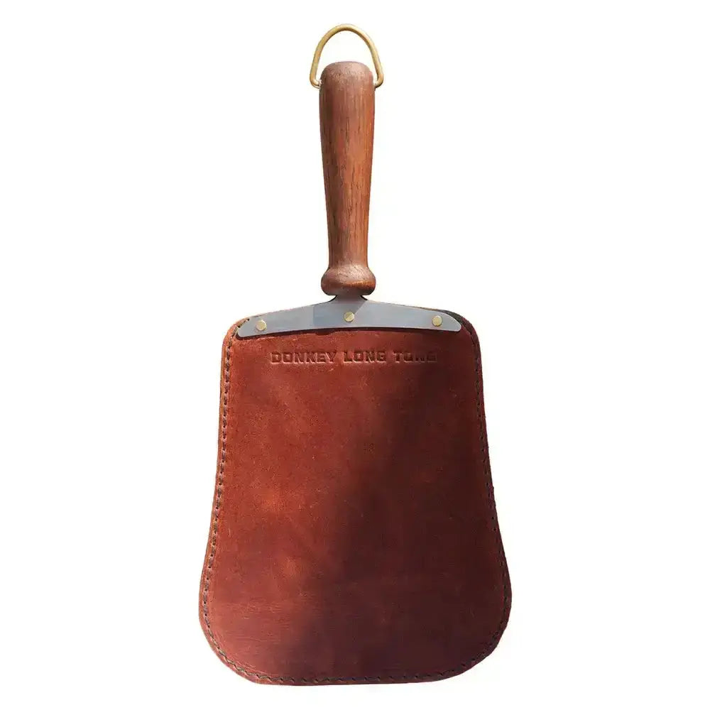Brown leather handheld kitchen paddle with wooden handle, embossed 'Donkey Long Tong', Cookin Stores