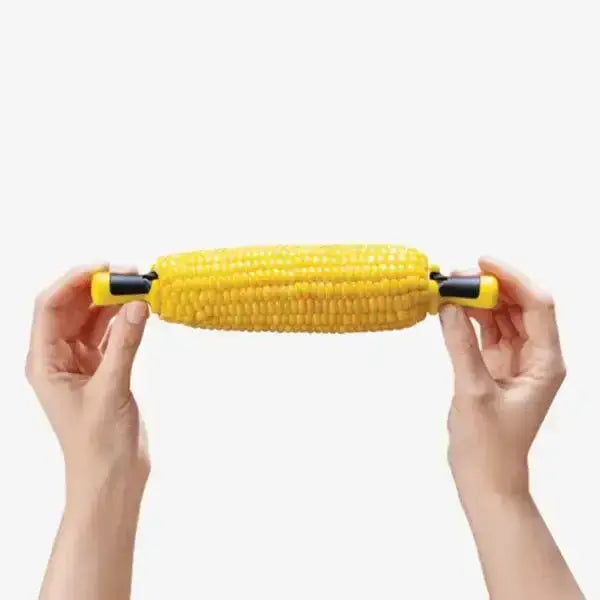 Hands holding corn on the cob with Dreamfarm Anchor Corn Lockorns from Cookin Stores