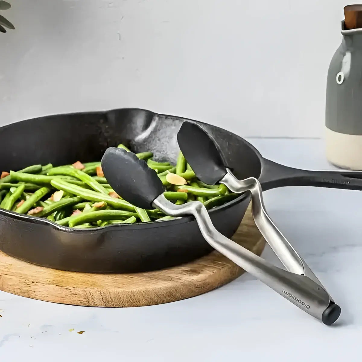 Dreamfarm Clongs black kitchen tongs on skillet with green beans, Cookin Stores kitchenware