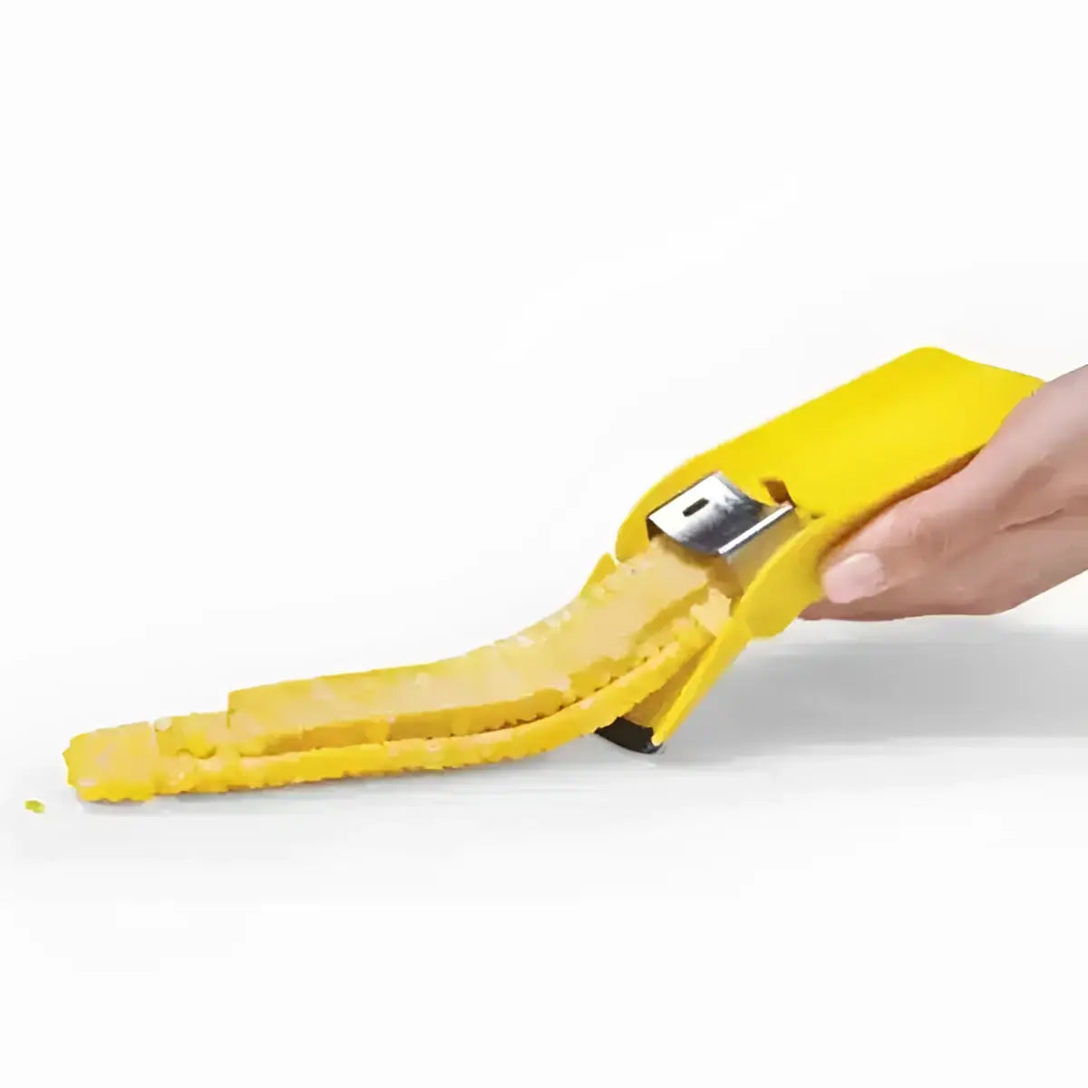 Hand using yellow Dreamfarm corn peeler to remove kernels, kitchen utensil at Cookin Stores