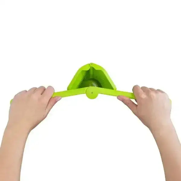 Hands using Dreamfarm Fluicer lime squeezer, green kitchen tool from Cookin Stores