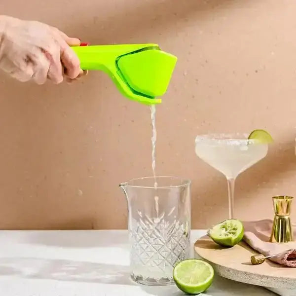 Dreamfarm Fluicer lime squeezer in use, fresh lime juice squeezed into glass, Cookin Stores kitchenware