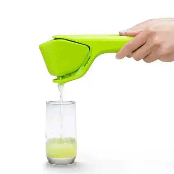 Green Dreamfarm Fluicer lime squeezer juicing into glass, premium kitchenware at Cookin Stores