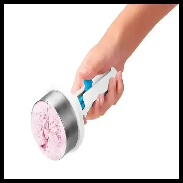 Hand holding Dreamfarm Icepo ice cream scoop with pink ice cream, kitchenware at Cookin Stores
