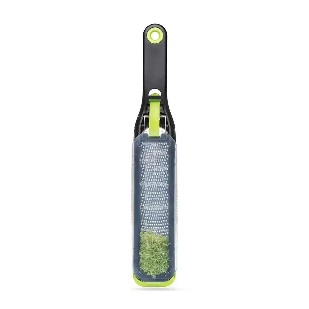 Grater with green handle on a white background