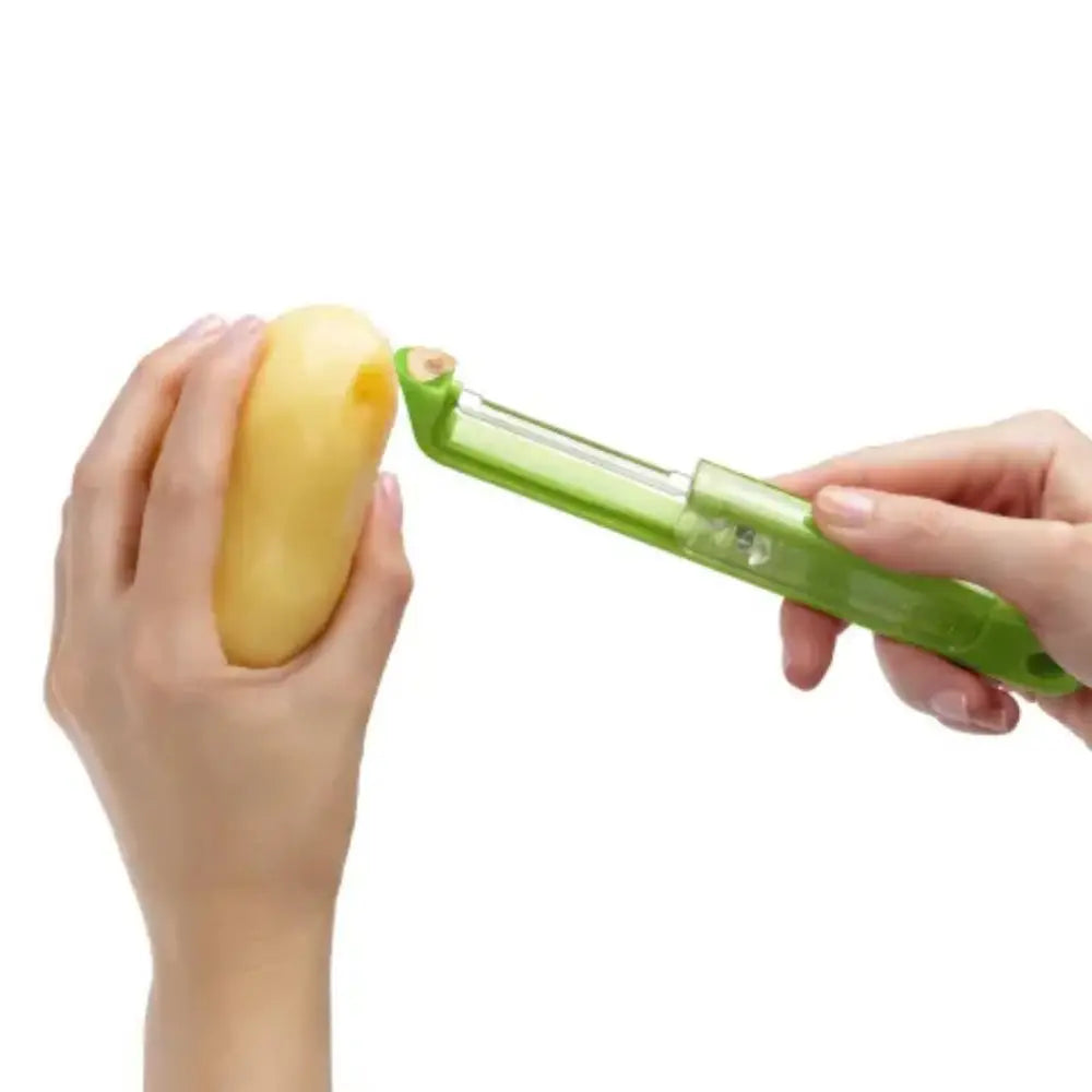 Hand using a green vegetable peeler on a yellow vegetable against a white background